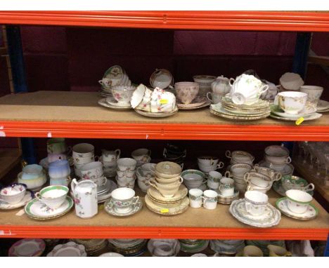 Five shelves containing a large quantity of assorted cups and saucers and other teaware to include Royal Albert