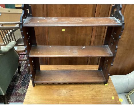 Edwardian hanging shelf with pierced decoration, 56.5cm wide, 15cm deep, 60cm high