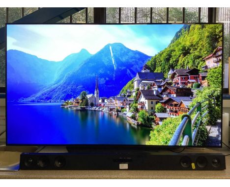 LG OLED flatscreen smart television, model number OLED55B9PLA with remote control, together with an LG sound bar model number