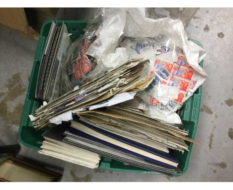 Green tub of old postage stamps and First Day Covers.