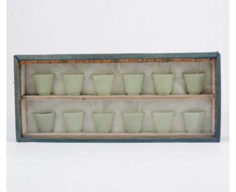 Set of twelve celadon coloured jade wine cups, flare form, 4cm, in a fitted case.