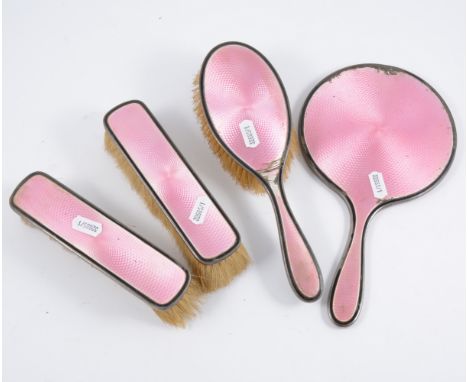 Silver and pink enamel four-piece dressing table set.