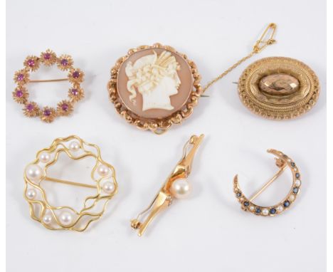 Six gold and yellow metal brooches. A 26mm open crescent set with nine sapphires and nine seed pearls, an 18 carat yellow gol