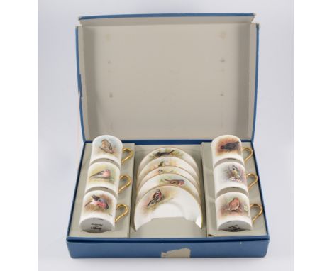 Set of six coffee cans and saucers, each hand-painted with a bird, signed James Skerrett, fitted in a Royal Worcester present