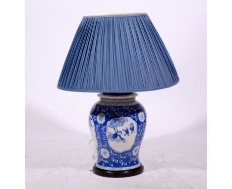 Modern Chinese table lamp, blue and white body in the Ming style, circular base, pleated shade, 81cm.