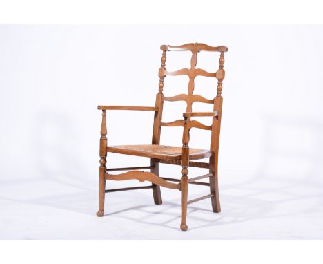 Beech wood nursing chair, ladder back, shaped arms, cane seat, turned legs joined by rails, 53cm.