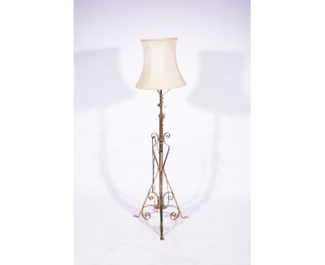 Edwardian brass standard lamp, scrolled adjustable frame converted to electricity, currently 160cm.