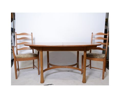 Ercol elm dining table, oval extending top, turned legs joined by stretchers, 216cm x 108cm maximum, height 74cm; and five la