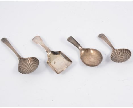 A Georgian silver caddy spoon, marks worn, two other silver caddy spoons with fluted bowls and a shovel shape silver caddy sp