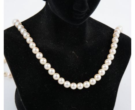 A rope of ninety-five 6.3mm cultured pearls, 60cm long with a 14k yellow metal fastener set with a small pearl.