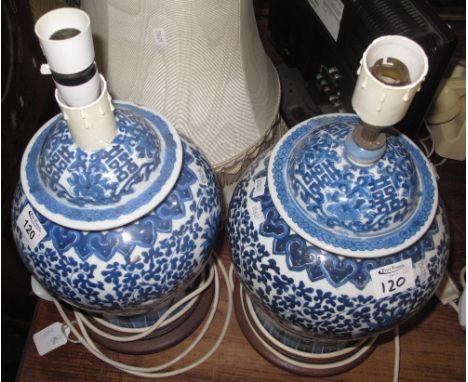 Pair of Chinese design blue and white porcelain lamp bases of baluster form on wooden bases with shades. (2)(B.P. 24% incl. V