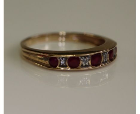 Ruby and diamond half eternity style ring on a 9ct gold band. (B.P. 24% incl. VAT)