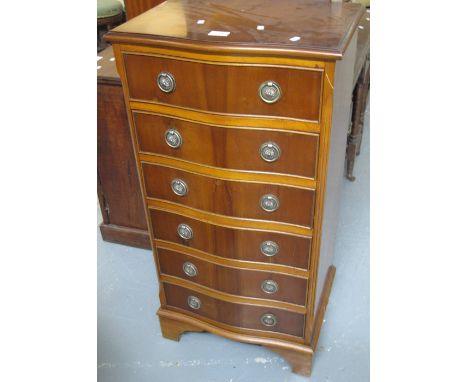 Reproduction yew wood serpentine fronted narrow chest of six drawers on bracket feet. (B.P. 24% incl. VAT)