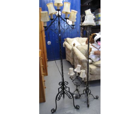 Two similar wrought iron scroll decorated standard lamps, together with a smaller table lamp. (3)(B.P. 24% incl. VAT)