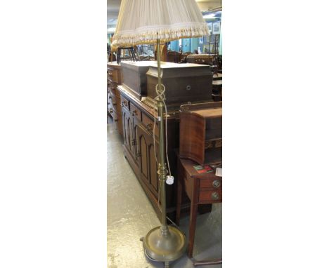 Heavy brass standard lamp with shade on a circular base. (B.P. 24% incl. VAT)