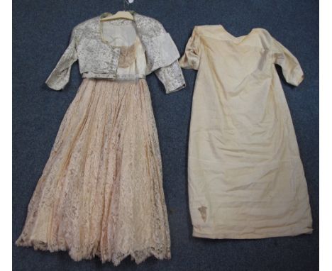 A vintage cream strapless dress with lace skirt and lace on the bodice, together with a light blue and gold brocade short jac