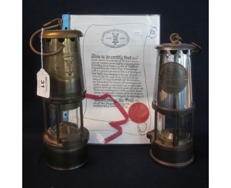 The Wolf Safety Lamp Company brass miner's safety lamp, with certificate. Together with another miner's safety lamp, unused. 
