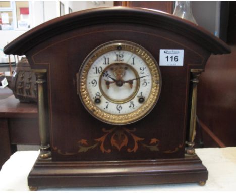 Edwardian mahogany two train architectural mantel clock with inlaid decoration, brass pillars and ceramic face with exposed e
