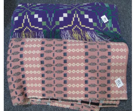 Two Welsh tapestry geometric carthen type blankets, one on a pink ground and the other fringed on a purple ground. (2)(B.P. 2