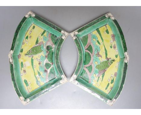 A pair of Chinese famille verte biscuit fan-shaped sweetmeat dishes, Kangxi, 20 cms wide.