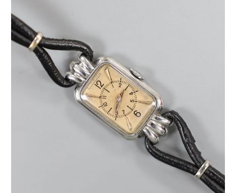 A lady's Art Deco steel Jaeger Le Coultre manual wind wrist watch, on fabric strap.