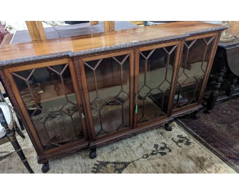 A 1920's Chippendale revival glazed mahogany break front dwarf cabinet, width 160cm, depth 43m, height 88cm