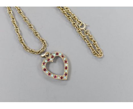 A modern 9ct gold, ruby and white opal set heart shaped open work pendant, 27mm and a 9ct gold chain, 38cm, gross weight 10.1