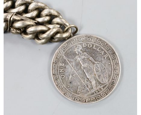 A German white metal and enamel bangle(a.f.) and an 835 white metal curb link bracelet hung with a one dollar coin.