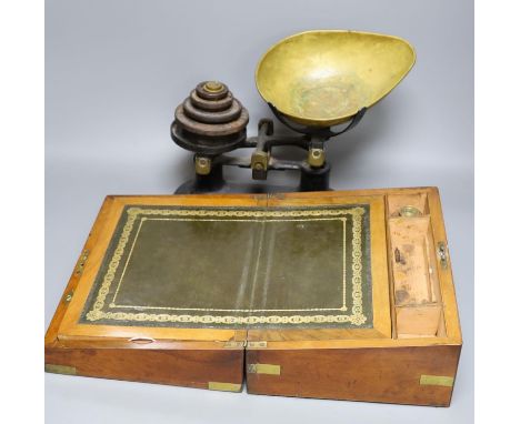 A Victorian walnut writing slope and a set of Victorian cast iron scales and weights (2), writing box 30 cms wide x14 cms hig