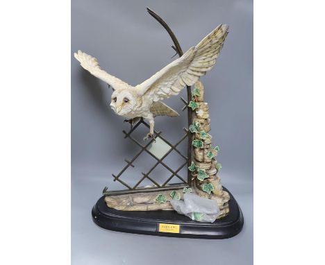 A large ceramic barn owl, on stand, 64 cms high.