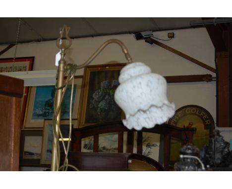 A turned brass standard lamp having a mottled and shaped milk glass shade, together with a Tiffany style table lamp (2)