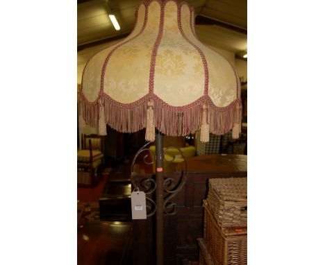 A painted wrought metal standard lamp