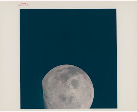 Jack Swigert or Fred HaiseNearly full Moon seen through the spacecraft window during the homeward journey11-17 April 1970Vint