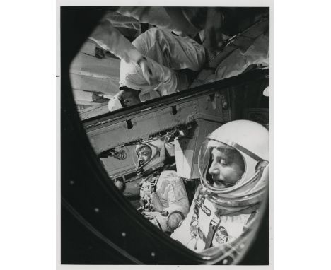 NASAA group of five photographs, comprising:1) Gus Grissom and John Young after insertion into the 'Molly Brown' capsule 23 M