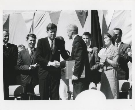 A set of three photographs:1) NASAPresident John F. Kennedy presents an award to John Glenn after the historic first U.S. orb