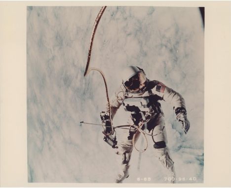 James McDivittTied to a tether, Ed White performs the first American spacewalk and floats in zero gravity above the cloud cov