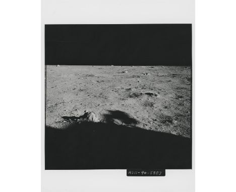 Buzz AldrinRare photograph; lunar landscape looking north-west featuring a field of boulders at Tranquility Base, shadow of t