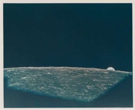 Frank BormanWhile the spacecraft orbits the Moon, the Earth emerges above the lunar horizon. This is the third earthrise witn