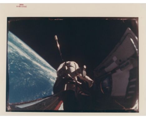 NASARichard Gordon performs the first EVA. The photograph is a still from a 16mm Maurer camera attached by Richard Gordon to 