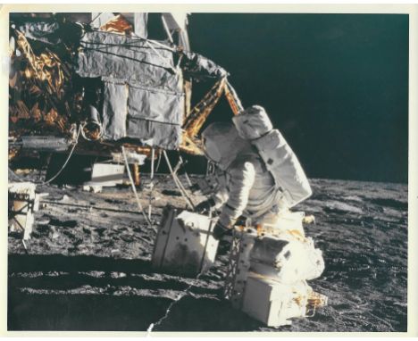 Charles Conrad or Alan BeanA set of three photographs, comprising:1) Alan Bean prepares to remove the scientific experiments 