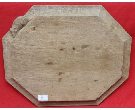 A Robert Thompson of Kilburn (1876-1955) "Mouseman" carved wood breadboard, of canted form with signature mouse to the edge, 