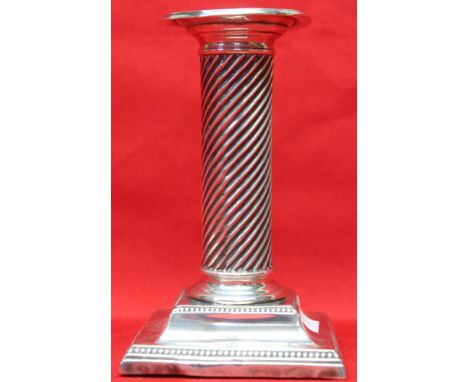 A column design silver candlestick, raised on square stepped base, marks rubbed, 13.5cm high