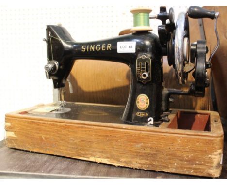 A vintage Singer sewing machine in wooden carry case