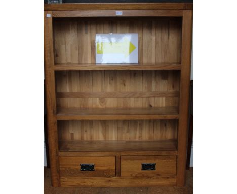 a modern beech three shelf bookcase with 2 drawers below