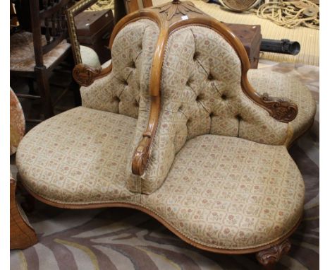An Edwardian satin wood four seated conversation chair ornately carved with contemporary button back upholstery