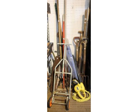 A wide selection of garden tools including an electric hedge trimmer, forks, rake etc