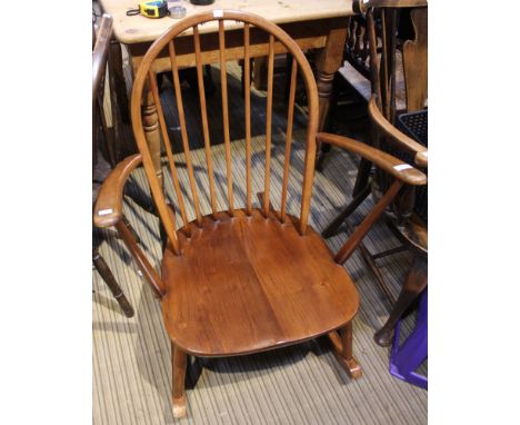 An Ercol bow spindle back rocking chair with splayed arms