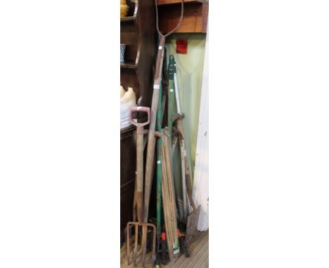 A collection of vintage wooden handled garden tools, canes etc