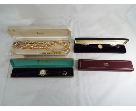 A case containing two costume pearl necklaces, two lady's vintage wristwatches one Rotary the other Lorus and a further empty