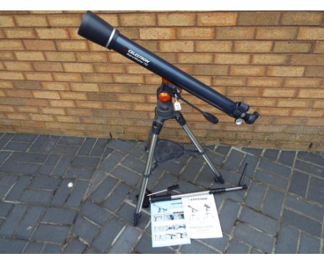 A Celestron Astro Master 70 with tripod stand, instruction manual, lenses, DVD and carry case bag also included in the lot is